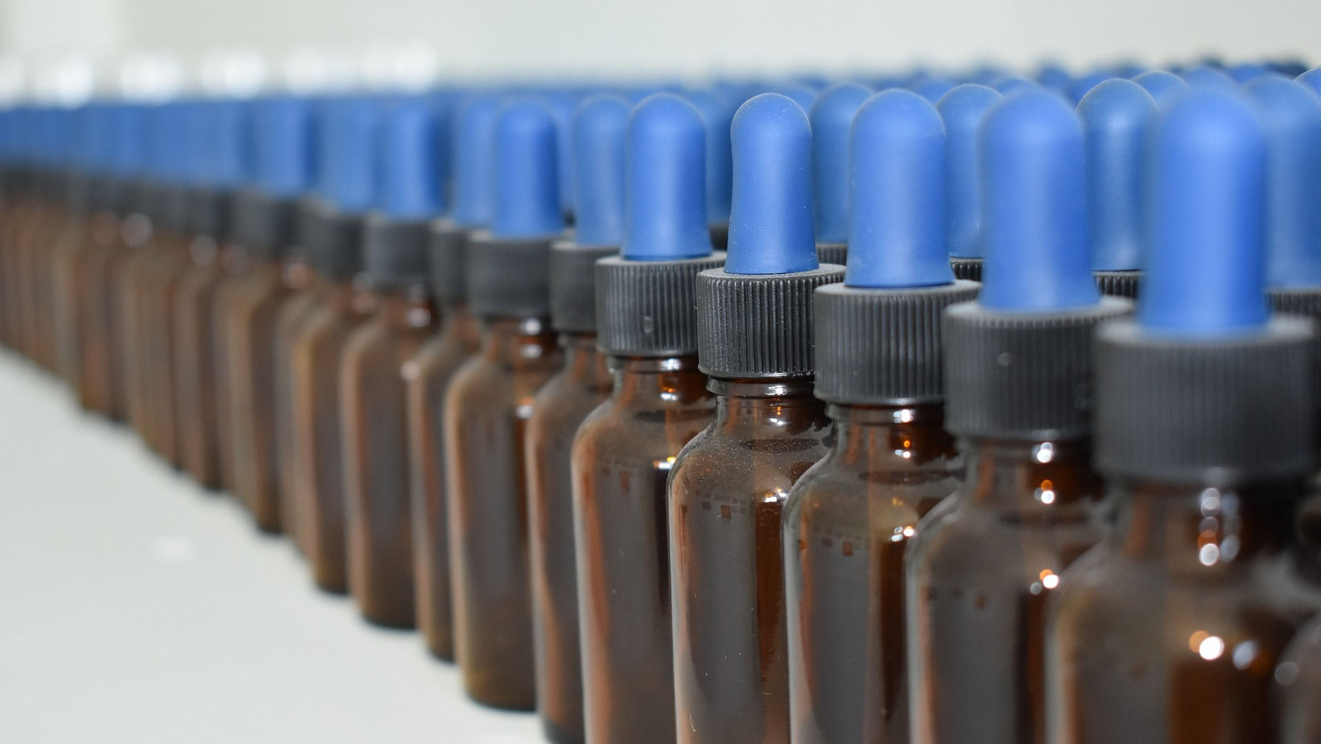 Row of unfilled homeopathic solution bottles
